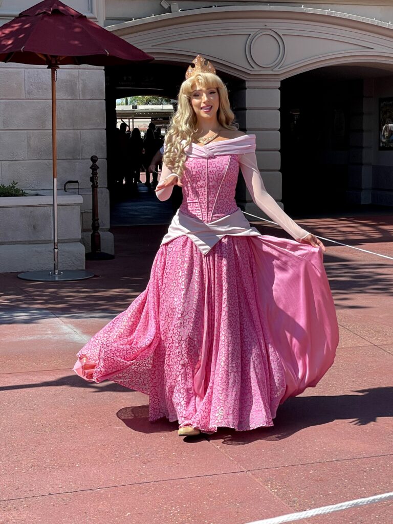 Premium Photo | Disney princess with long black hair and tiable in pink  dress generative ai