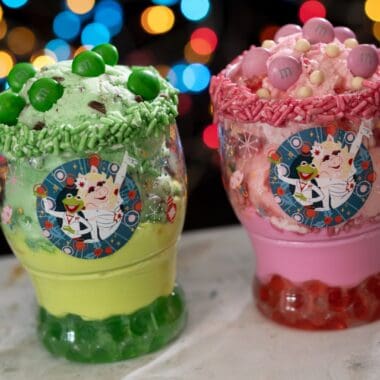 Colorful holiday-themed Disney character ice cream sundaes in festive mugs.