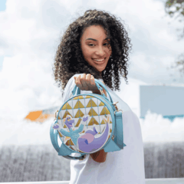Colorful Disney-themed backpack featuring a mermaid design, perfect for Disney fashion fans and accessory lovers.