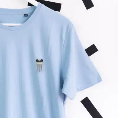Mickey Mouse inspired embroidered face on light blue casual t-shirt for Disney fashion fans.