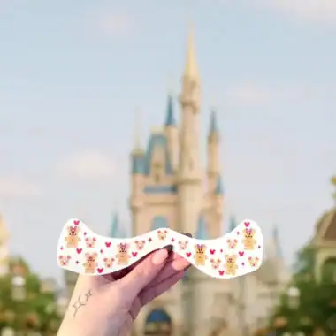 Colorful Disney-themed glasses featuring teddy bear and crown motifs, ideal for Disney fans and theme park visits.