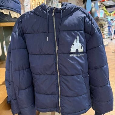 Stylish navy blue Disney puffer jacket with castle logo and “Walt Disney World” embroidery. Perfect for cold weather and Disney fans.