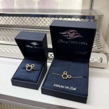 Elegant Mickey Mouse ring and bracelet in navy jewelry boxes, perfect Disney Cruise Line accessories.