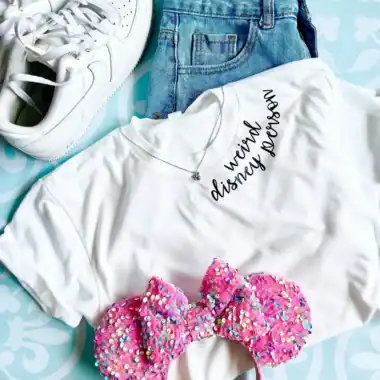 Bright white sneakers, denim shorts, "we’re Disney bound" tee, and sparkly pink Minnie headband.