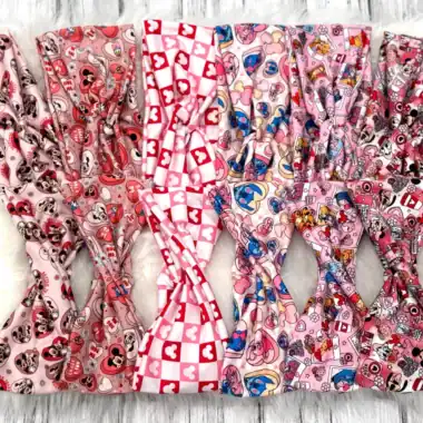 Colorful Disney-themed hair accessories featuring Mickey and Minnie Mouse, love hearts, and playful patterns for kids and adults.