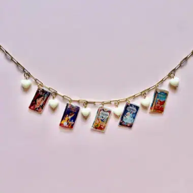 Delicate necklace featuring Disney princess vintage movie miniature charms and white heart accents, perfect for Disney fans.