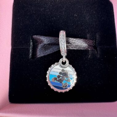 Enchanted Disney Mickey Mouse charm bracelet with sparkling stones in a pink jewelry box.