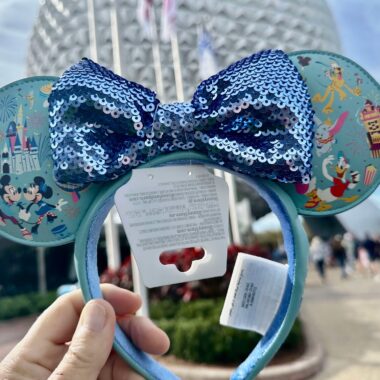 Vintage Disney Mickey Mouse ear headband featuring a glittery blue sequin bow. Perfect Disney accessory for theme parks or events.