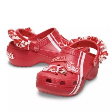 Red Disney-themed Crocs with varsity stripes and embellishments.