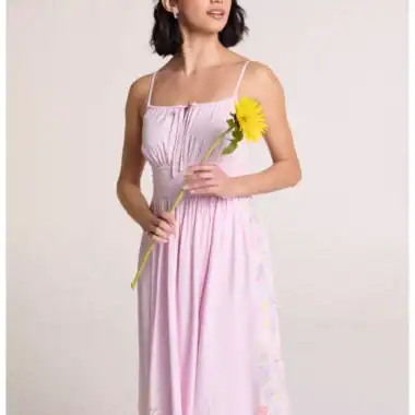 Woman in pink Disney princess-inspired dress holding a sunflower.