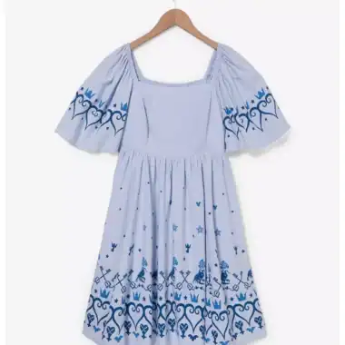 Child's blue dress with intricate Disney-themed embroidery and puffed sleeves.