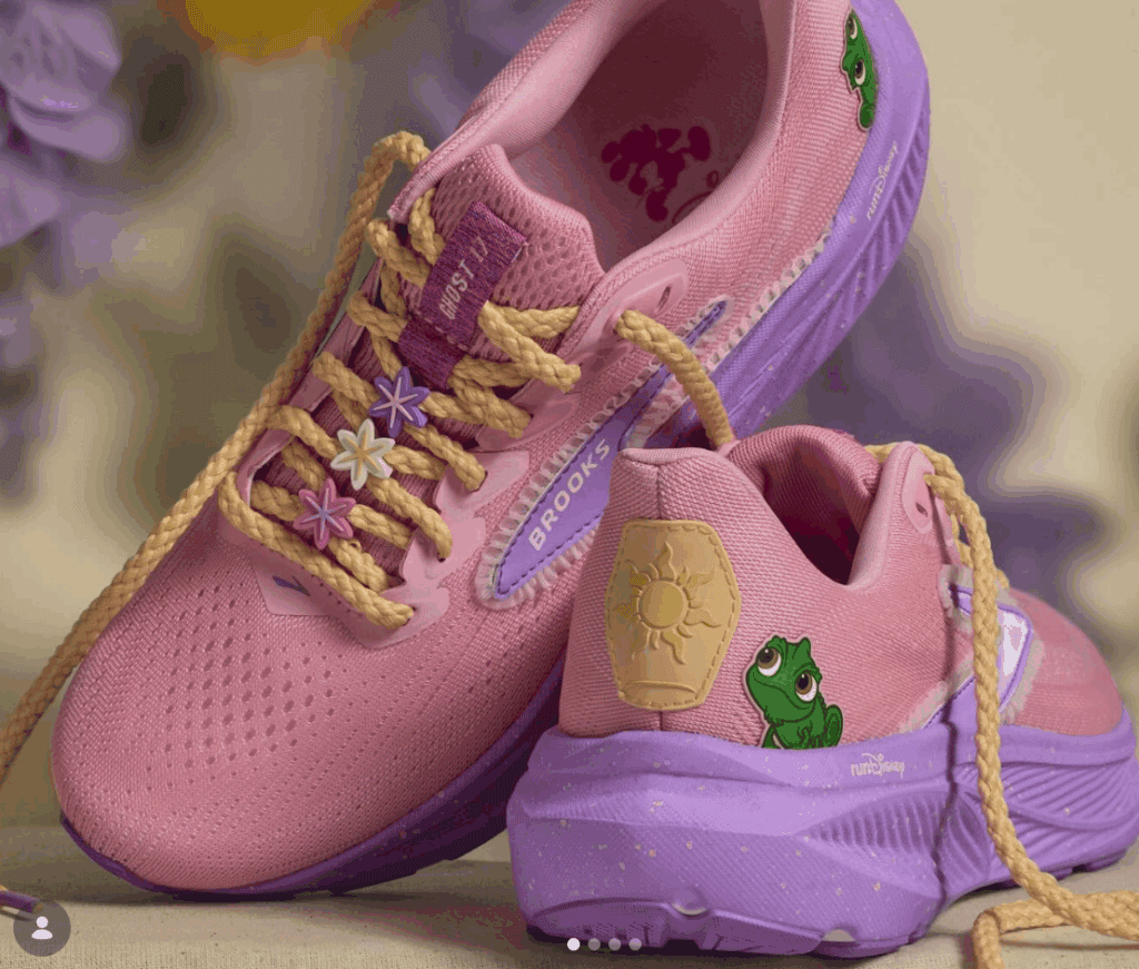 Cute pink and purple kids' sneakers featuring frog and sun motifs, ideal for Disney-themed fashion.