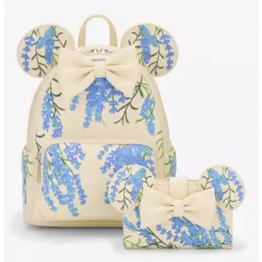 Backpack featuring blue floral pattern, mouse ears, and bow, inspired by Disney fashion accessories.