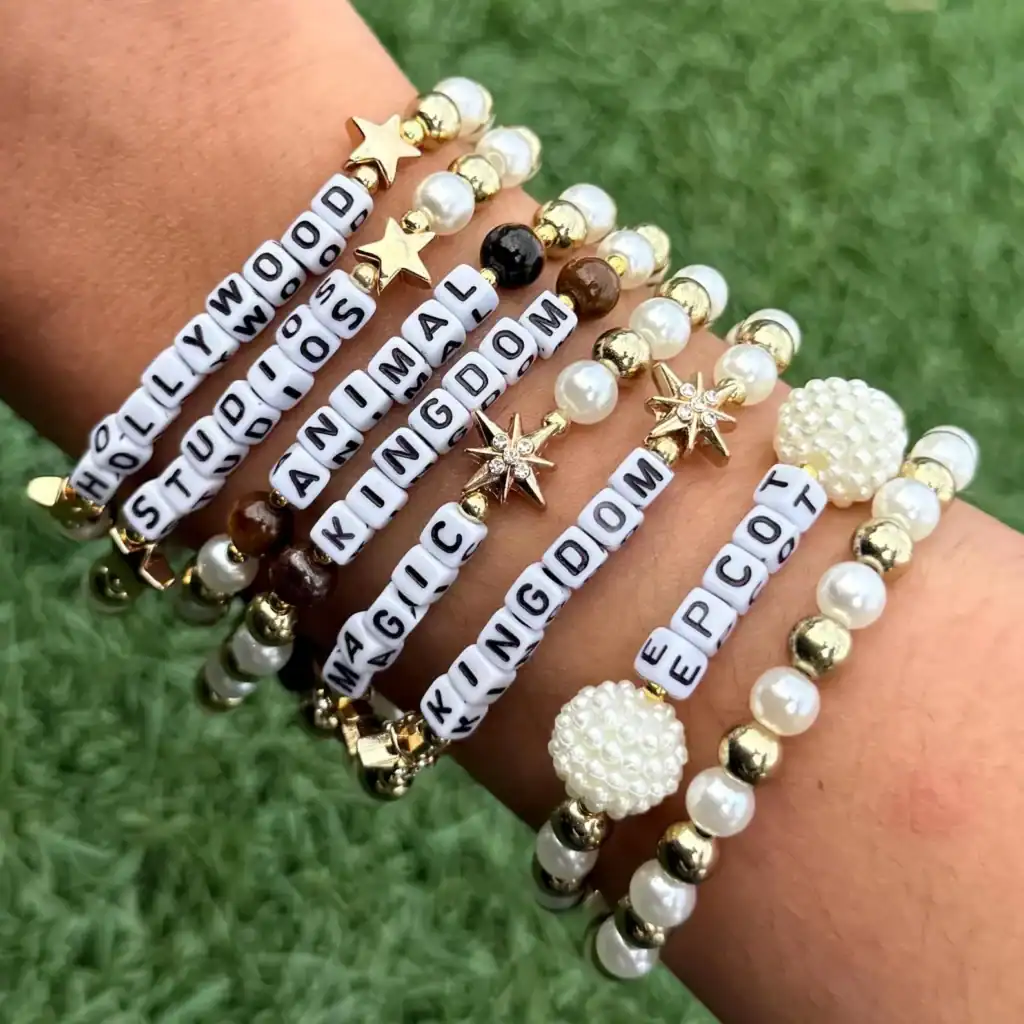 Colorful Disney-themed beaded bracelets with charms and word beads for fans.