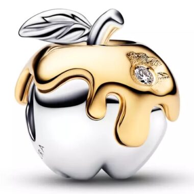 Elegant apple-shaped jewelry with gold and silver tones, adorned with a diamond accent.