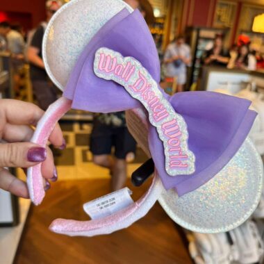 Disney World Minnie Mouse ears headband with purple bow and glittery ears.