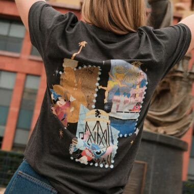 Black T-shirt featuring Disney castle and characters for Disney fashion fans.