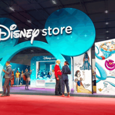 Disney Store booth at D23 Expo showcasing Disney merchandise and characters.
