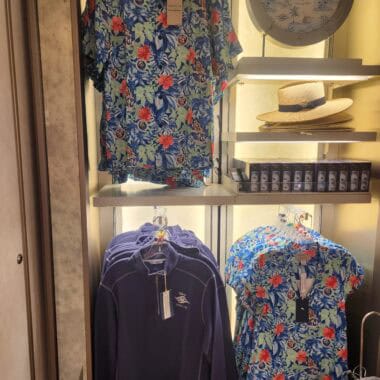 Colorful floral Hawaiian shirts and a navy jacket on display at Disney Fashionista.