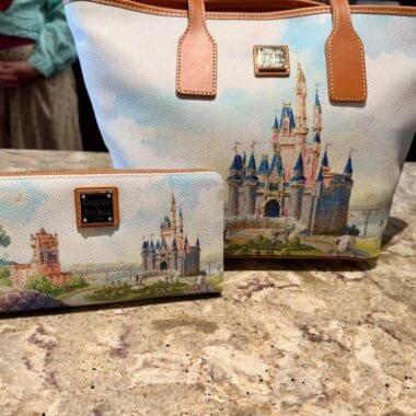 Disney castle tote bag and matching wallet with detailed castle design.