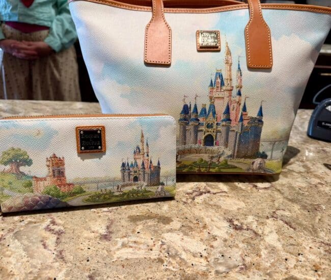 Disney castle tote bag and matching wallet with detailed castle design.